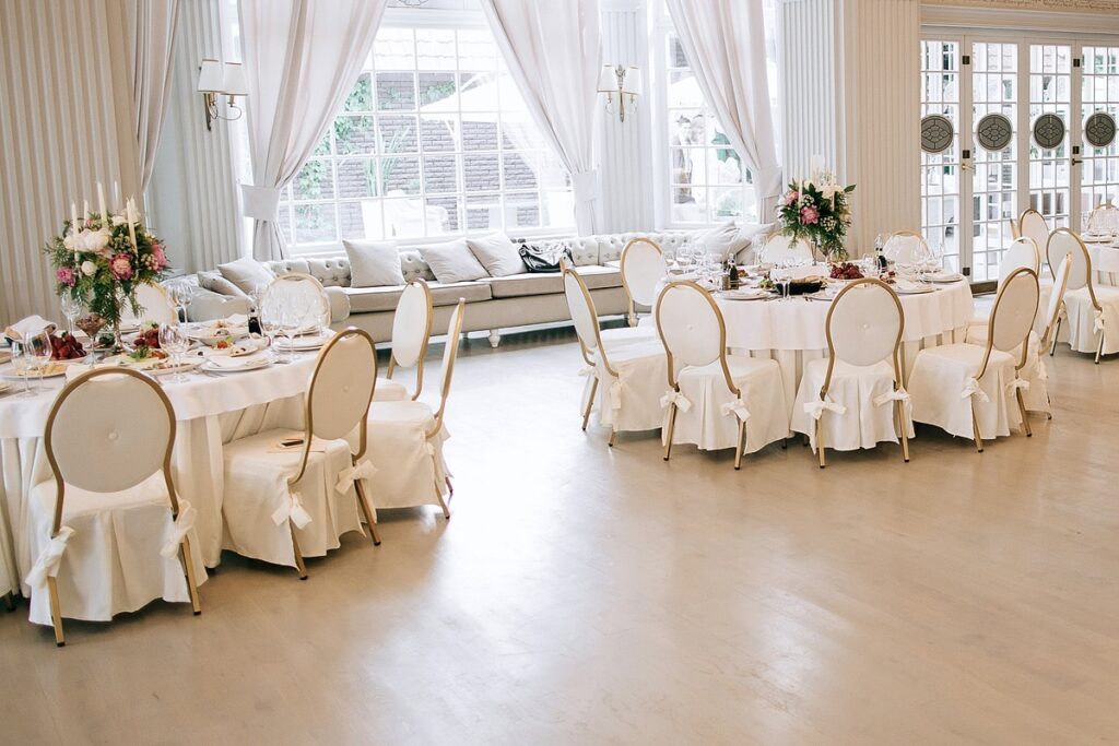 Wedding hall arranged using beautiful white and gold chairs